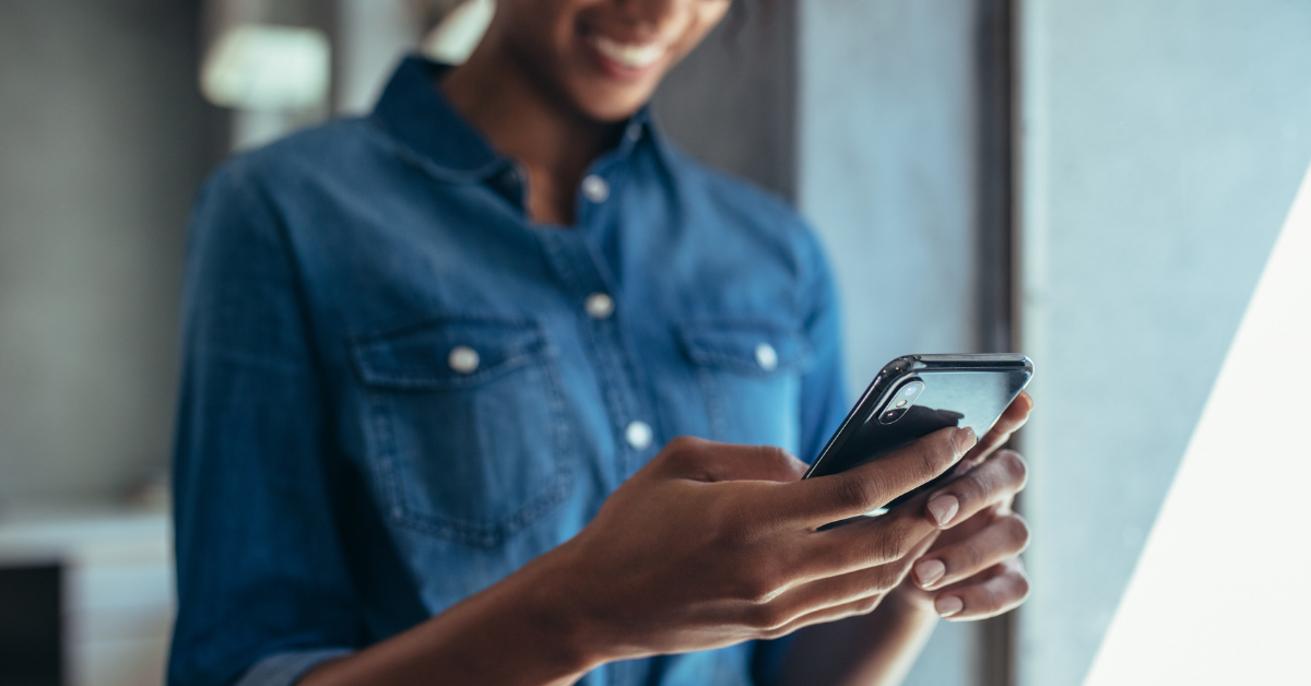 Woman is engaging with hybrid event via mobile phone