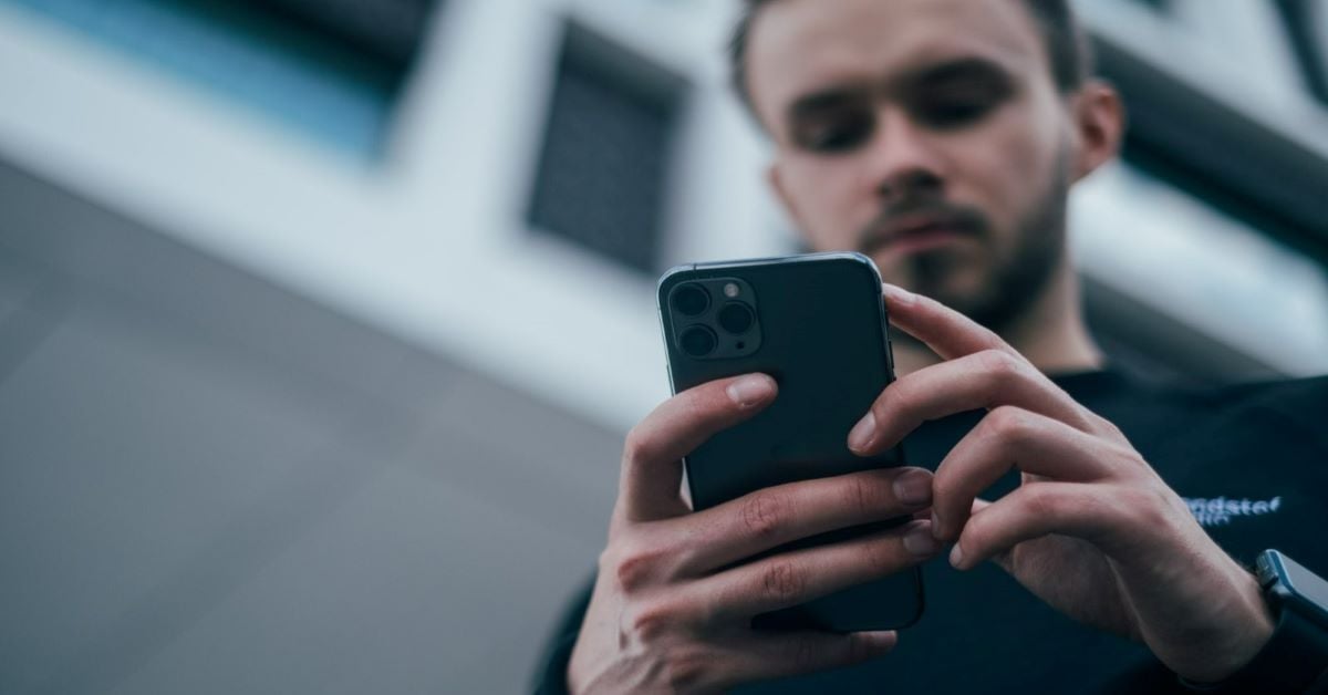 Man looking down at his cellphone