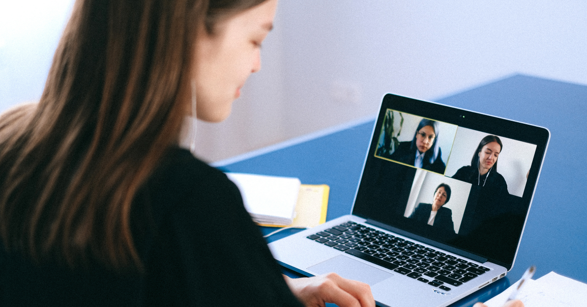 woman on video call with three 3 people laptop